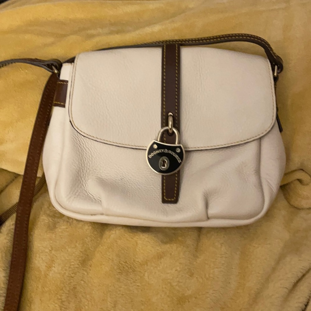 Cream Color Dooney and Bourke shoulder bag.